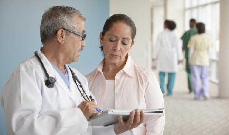 Doctors talking to woman in hospital