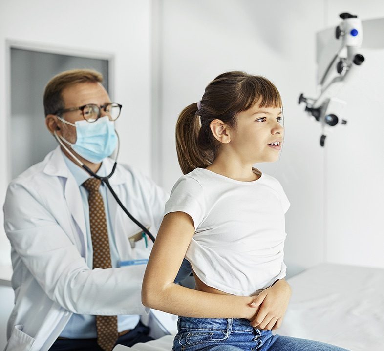 doctor checks heartbeat of patient